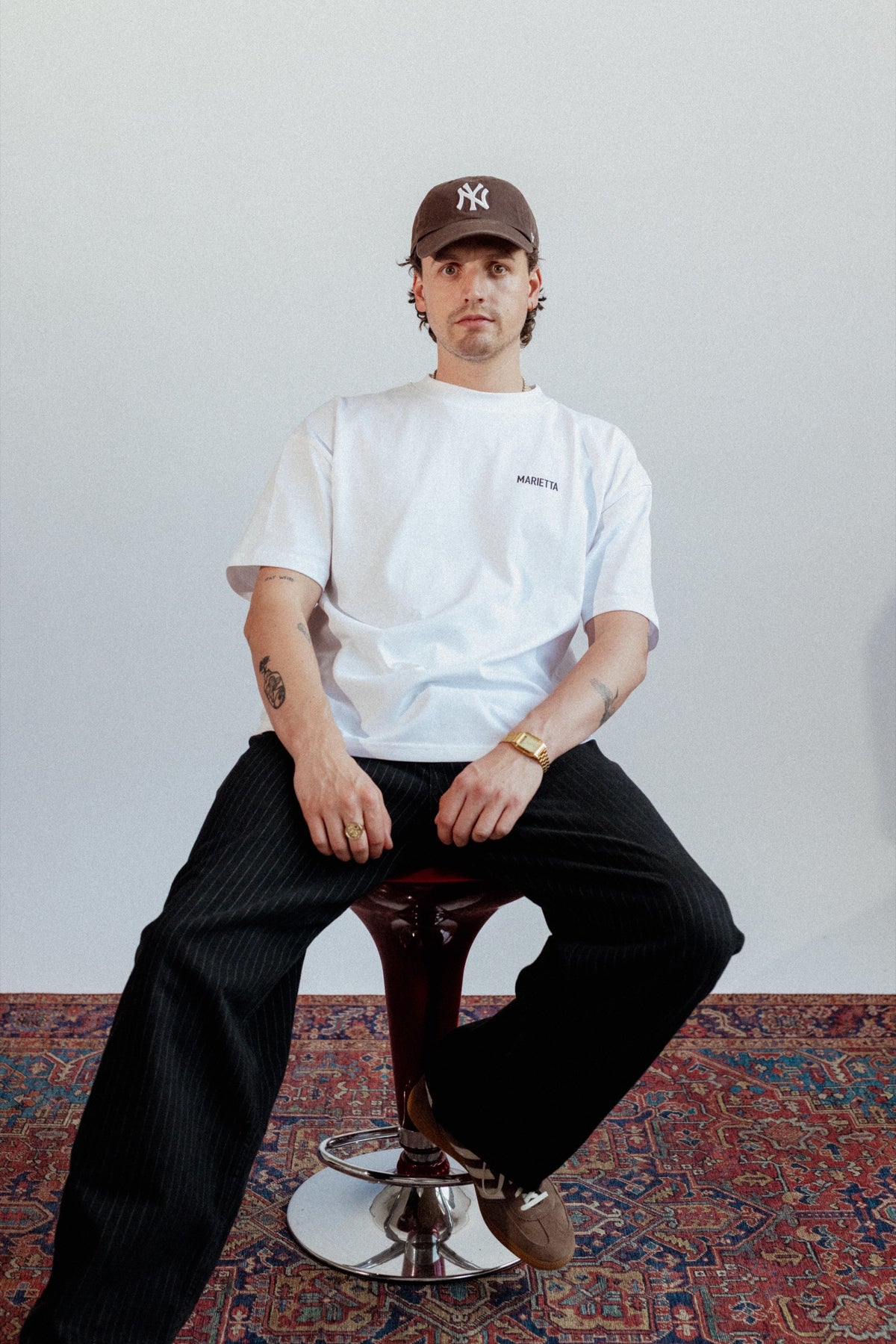 Marietta OG Tee, seated with cap